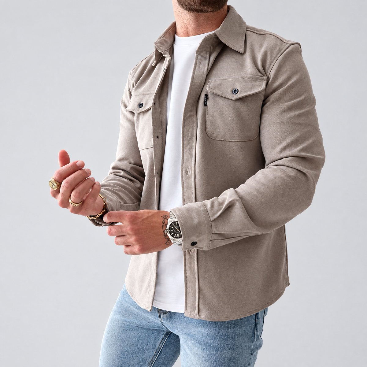 Men's casual shirt jacket with chest pockets in beige, worn open over a white t-shirt